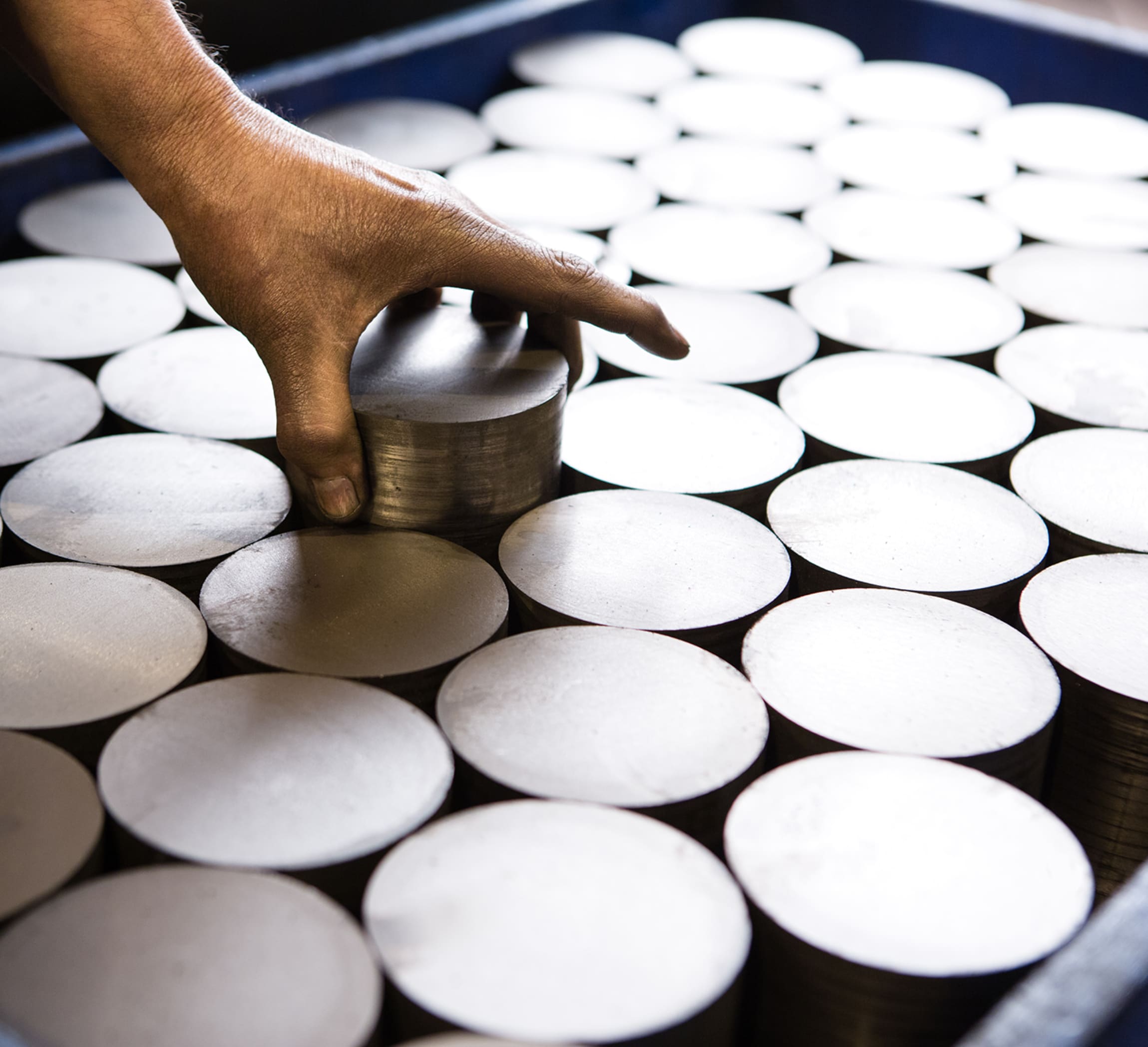 A photo of a man setting a piece of Dura-Bar into a group of others