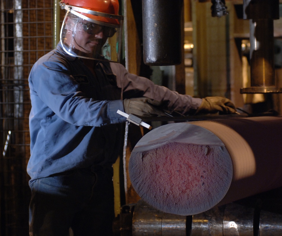 A man cutting a large iron rod