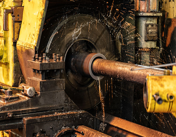 A large mill milling down a piece of iron
